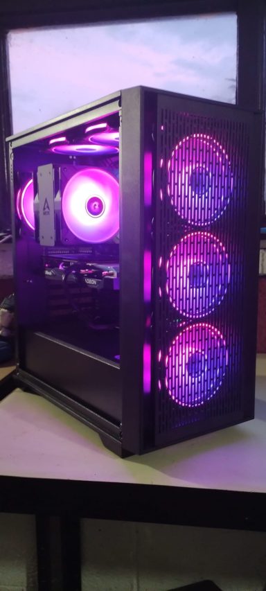 Ryzen 5 5600X/16GB DDR4/1TB SSD/RX6600 8GB A stylish black gaming PC case with purple LED lights and three visible fans.
