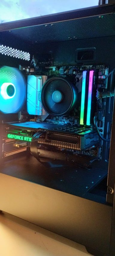 Ryzen 5 5600/16GB DDR4/1TB SSD/RTX3060 12GB A computer interior showing RGB lighting, cooling fans, and hardware components.