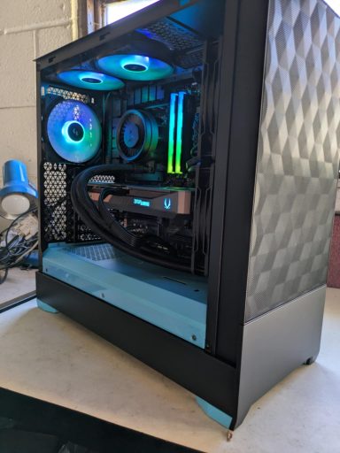 Ryzen 7 7800X3D/32GB DDR5/2TB SSD/RTX5070 12GB A sleek gaming PC with RGB lighting and transparent side panel.